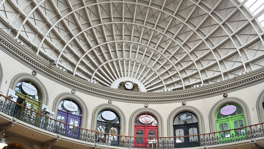 The domed roof of Leeds Corn Exchange with six coloured doors taken from basement level looking up at the roof