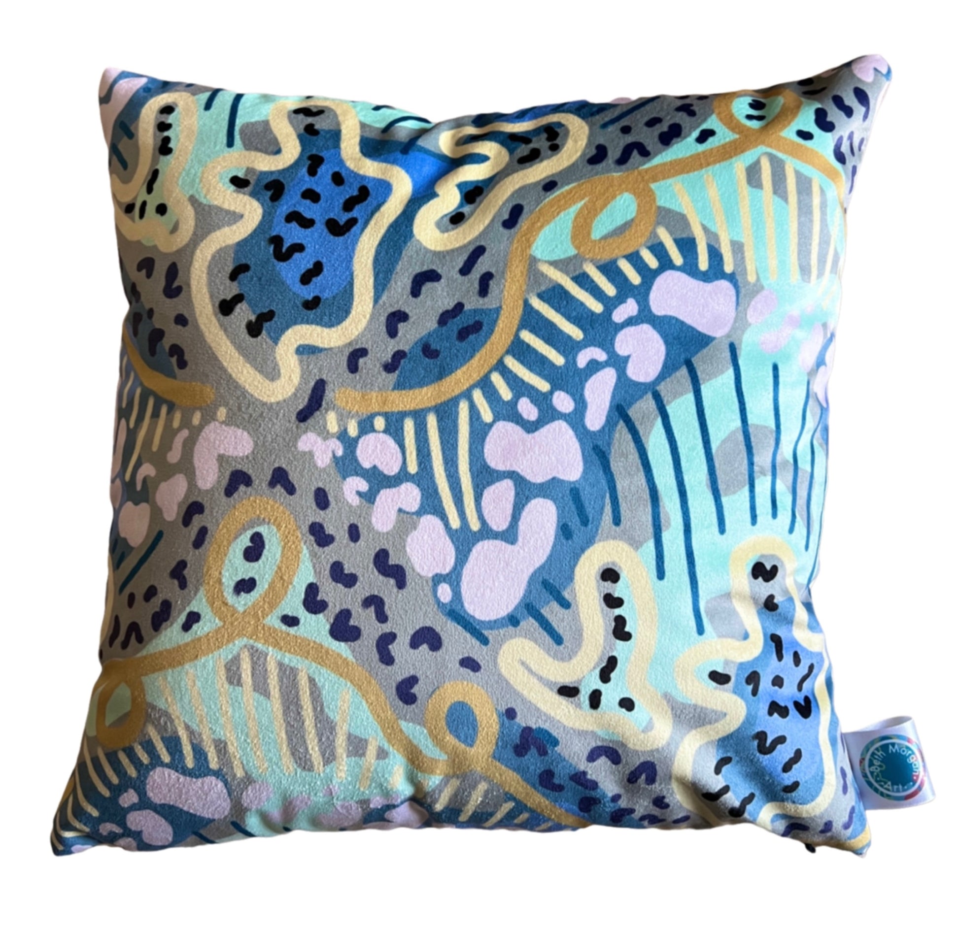 The front of the Clear Blue Skies cushion by Beth Morgan Art. It features abstract shapes and swirling lines in varying shades of blue, green and yellow.
