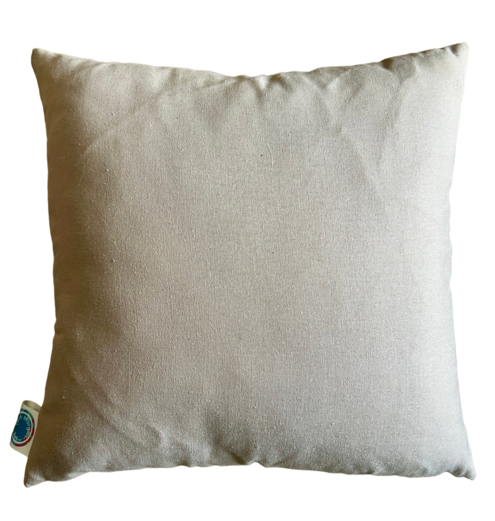 The back of the Clear Blue Skies Cushion made of plain beige fabric.