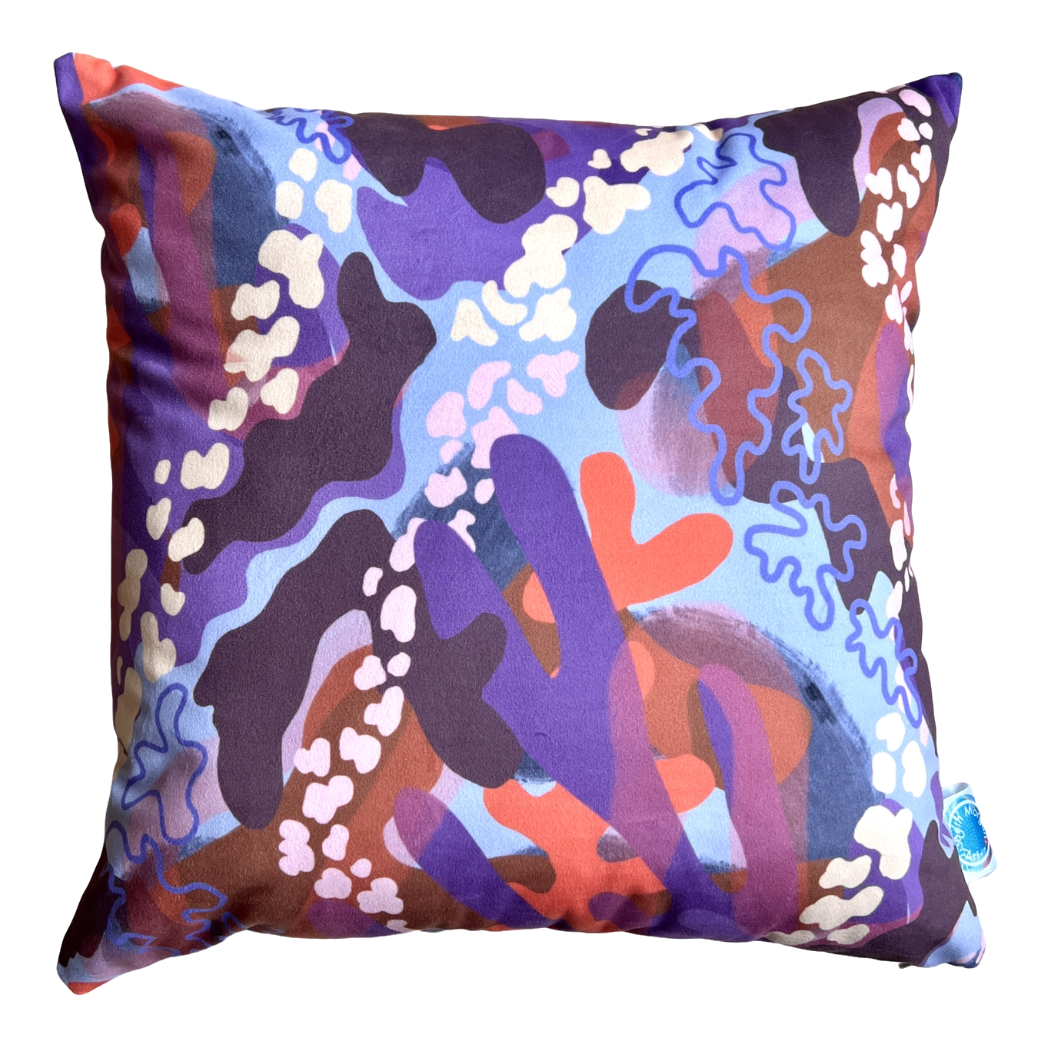 The front of the Blossom cushion by Beth Morgan Art. It features large and small abstract colourful shapes in different shades of purple, orange and pink.